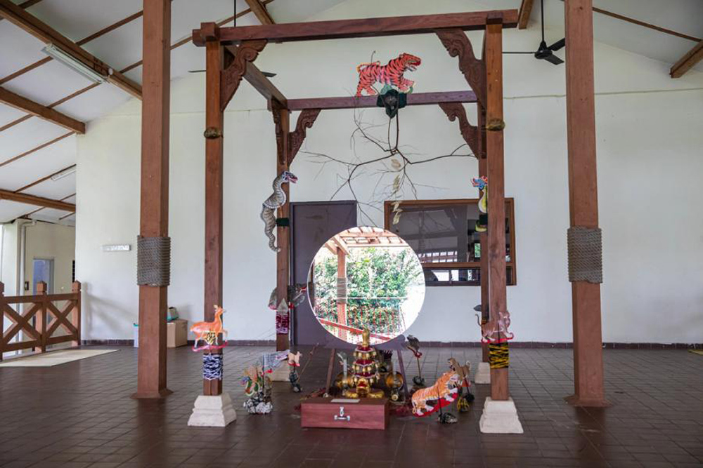 An installation with a mirror in the centre surrounded by different installations of animals.