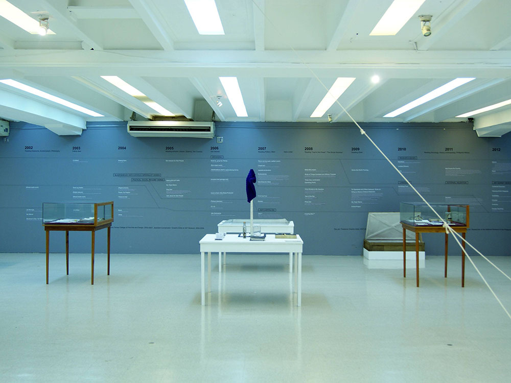 A room with tables and mindmap on a blue wall.