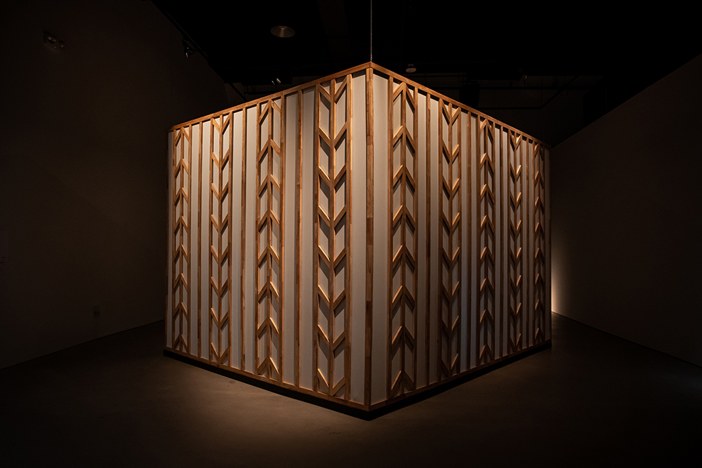 A cube installation featuring wooden fixtures.