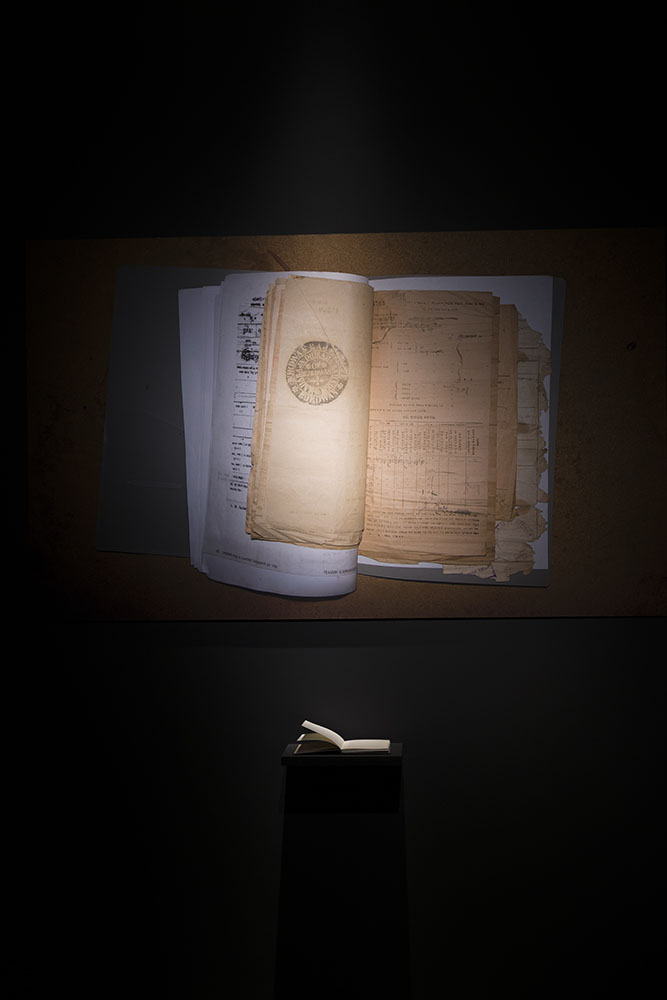 A book on a podium and a bird's eye view of the book laid out.