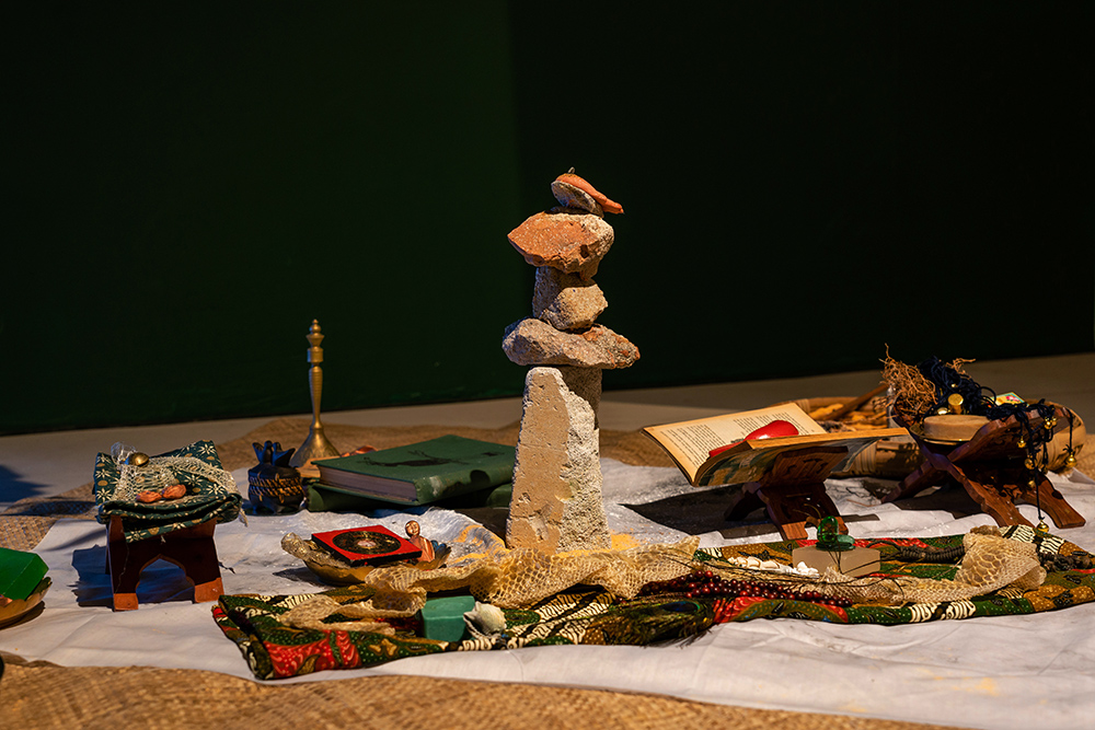 A rock sculpture surrounded by different items.